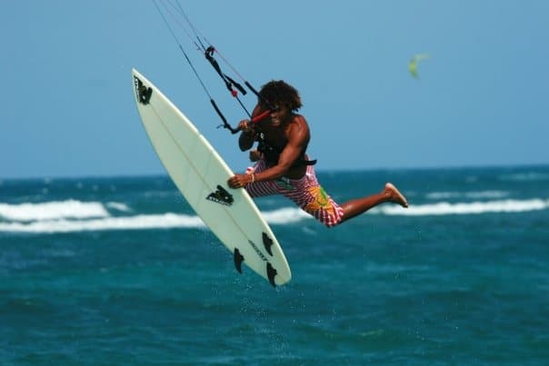 A man kiteboarding in the ocean, enjoying the thrill of the sport while harnessing the power of the wind.