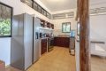 A fully equipped kitchen with a refrigerator, stove, and sink in Surf Salvación