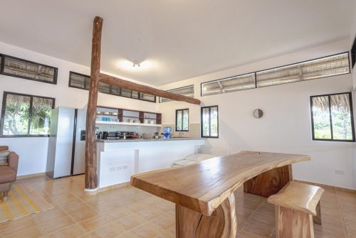 A kitchen with a wooden table and two benches